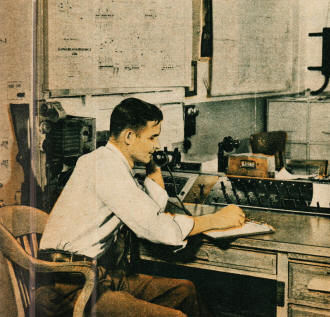 Electric sub-station operator maintaining contact with a field lineman who reports over short-wave radio - RF Cafe